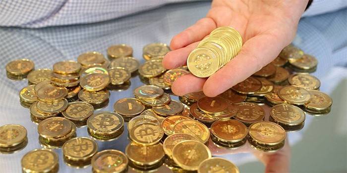 Man holds bitcoins.