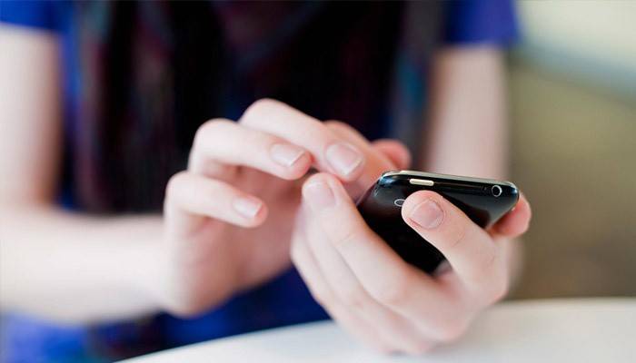 Niña sostiene un teléfono inteligente