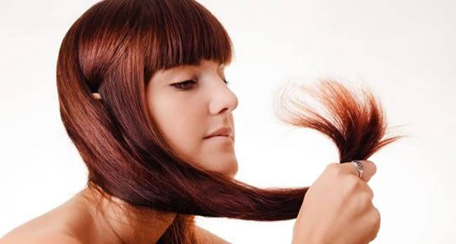 Girl studies the ends of hair