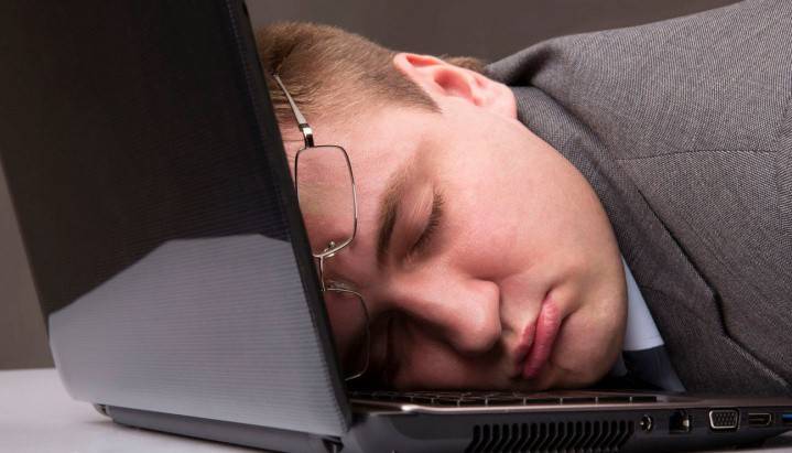 Ember alszik egy nyitott laptop
