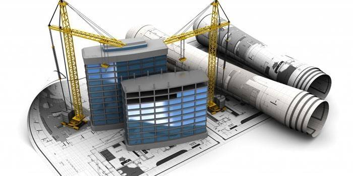 Casas e guindastes em um plano de construção