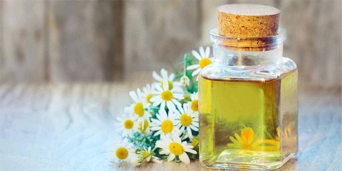 Essential oil and chamomile flowers