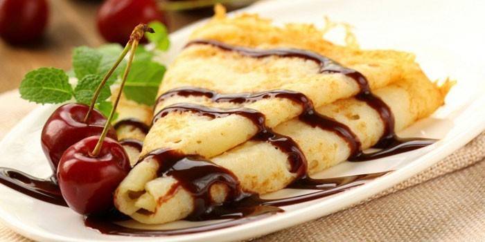 Pfannkuchen mit Schokoladensauce und Kirsche