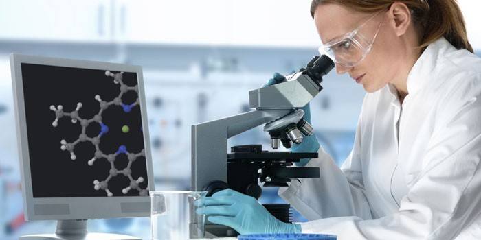 Ragazza che osserva tramite un microscopio
