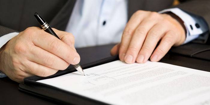 Man signs a contract
