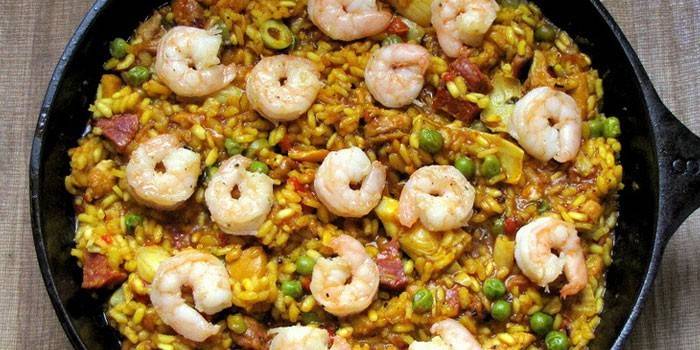 Paella con carne e gamberi in padella