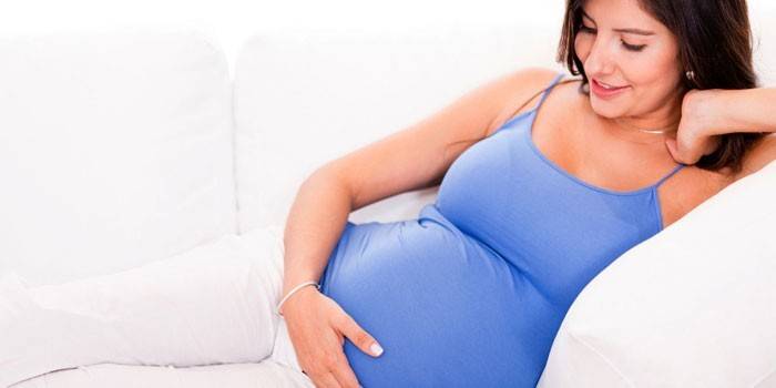 Niña embarazada en el sofá