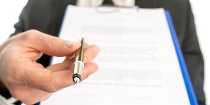 A man with a pen and a folder with papers