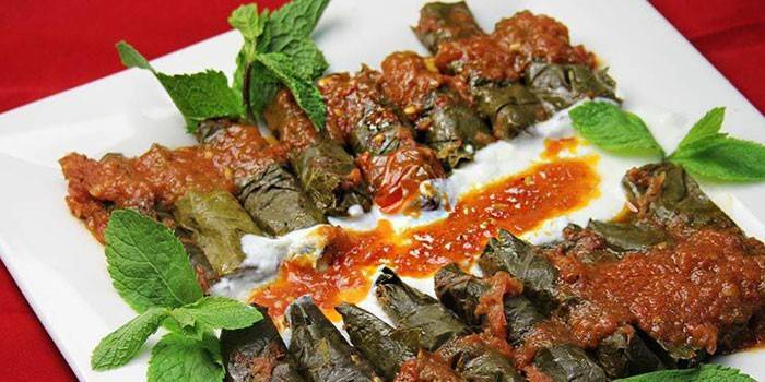Gruzijas stila dolma ēdiens ar tomātu mērci
