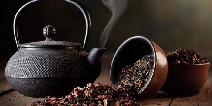 Té negro con aditivos y una tetera con agua hirviendo.