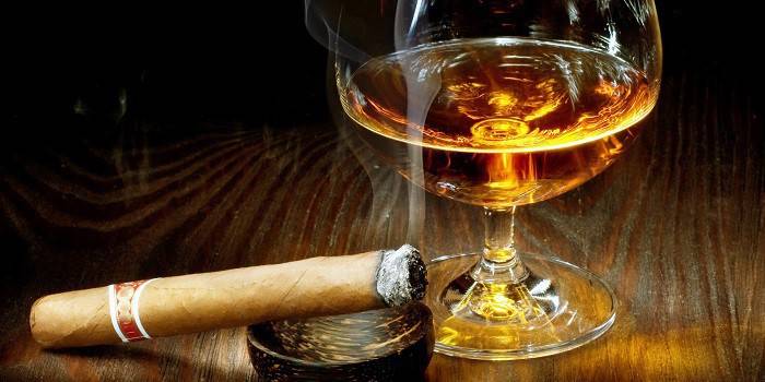 Trabuc într-o scrumieră și un pahar de alcool