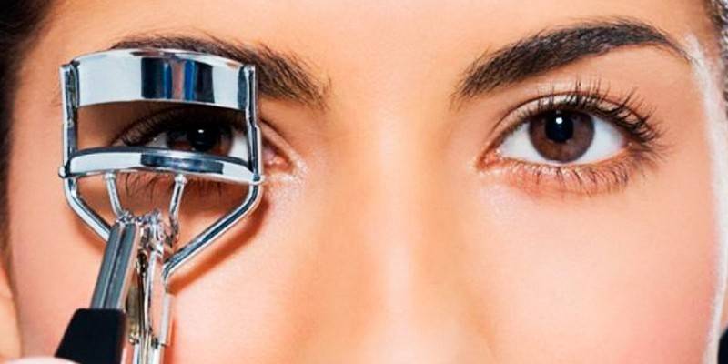 Girl curls her eyelashes