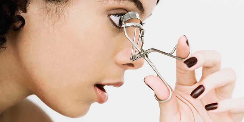 Girl with eyelash curlers