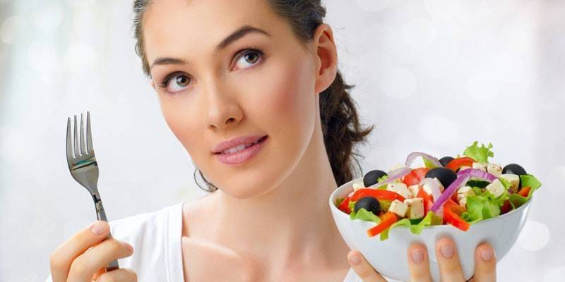 Girl with a plate of salad in hand